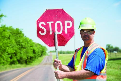worker-holding-up-a-stop-sign.jpg