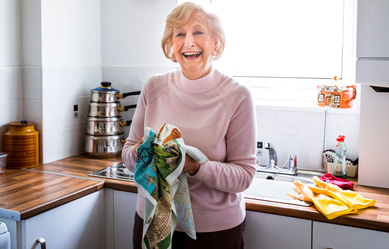 Senior woman drying dishes