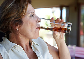 mature lady drinking soda