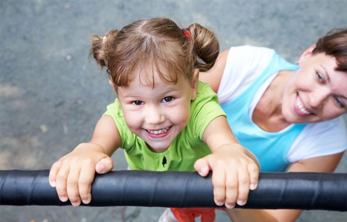 girl hanging on bar
