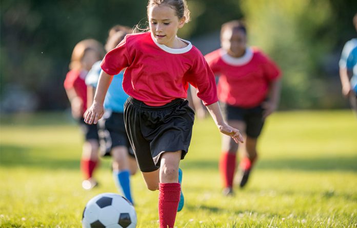 girl playing soccer