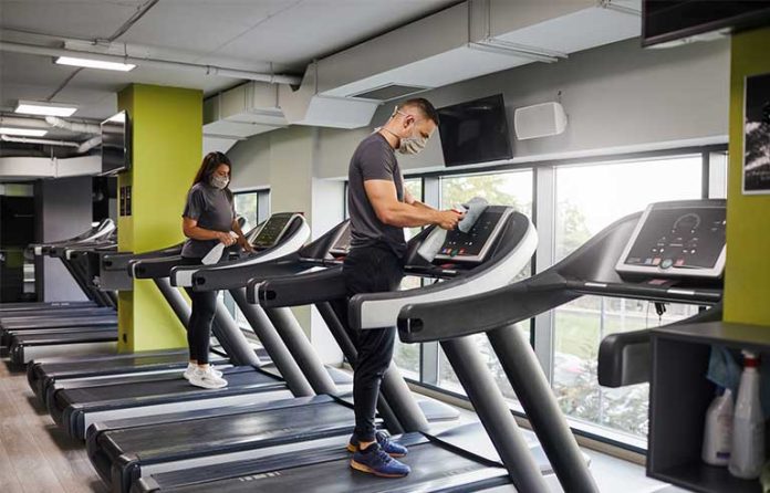 gym staff-sanitizing equipment