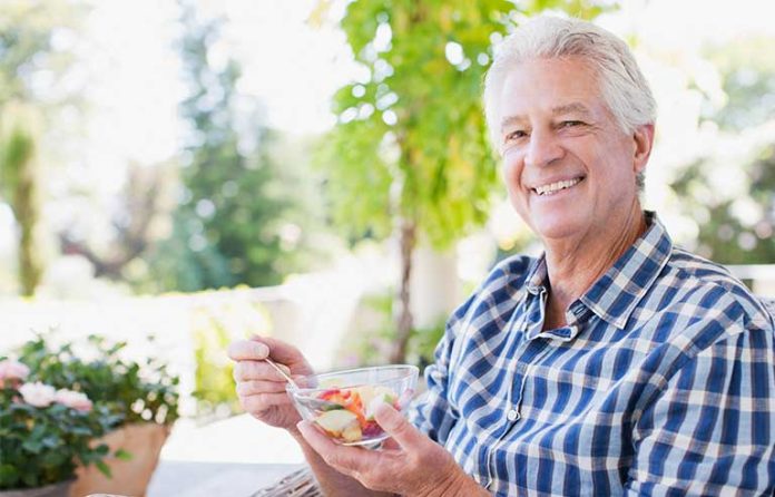 man eating veggies
