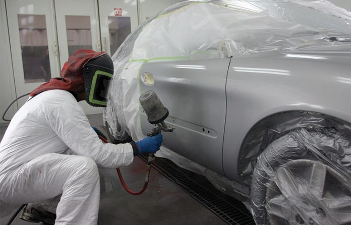 man painting car