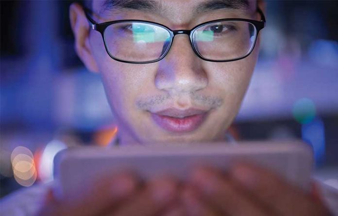 man using phone at night