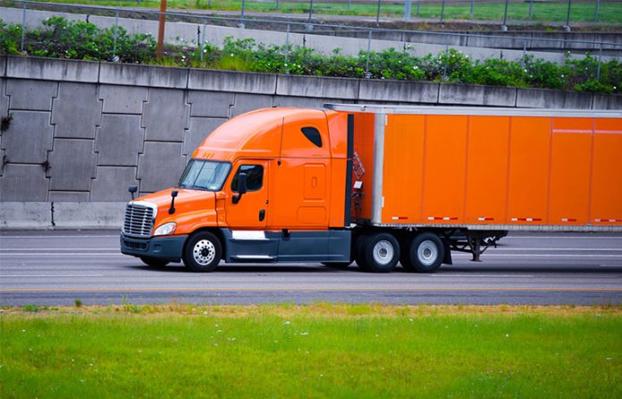 orange semitruck on highway