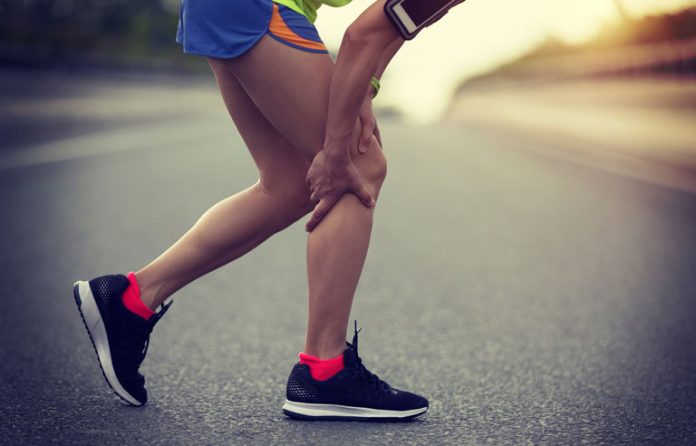 Woman holding leg