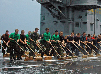 Sailors clean the deck
