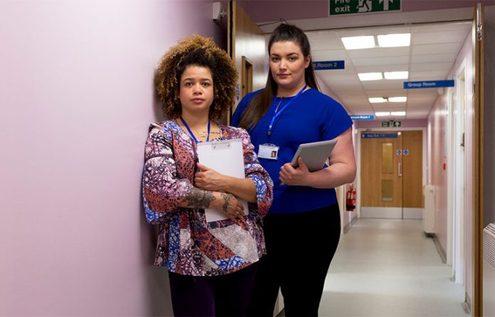 Nurses against pink walls