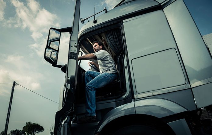 truck driver getting off truck