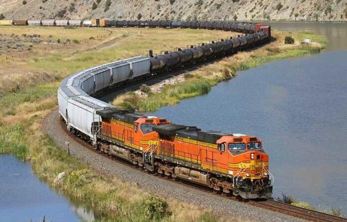 Orange freight train near water