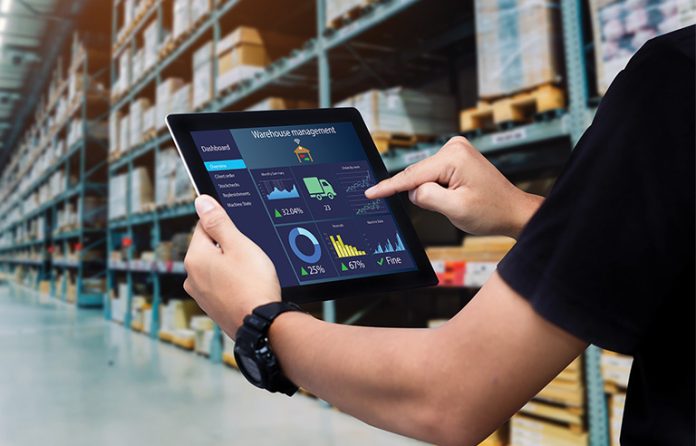 Digital screen in a warehouse setting
