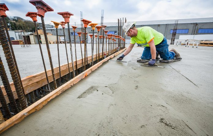 Construction worker smoothing concrete