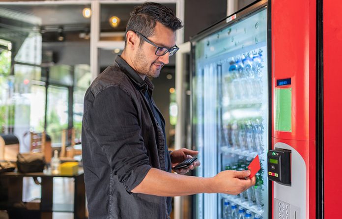 Man getting water from a vending machine