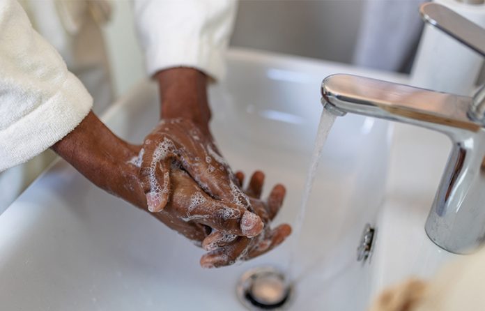 Black woman washing hands