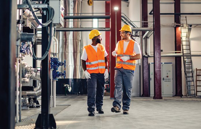 Two industrial workers walking the shop floor