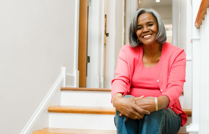 Woman sitting on stairs in home