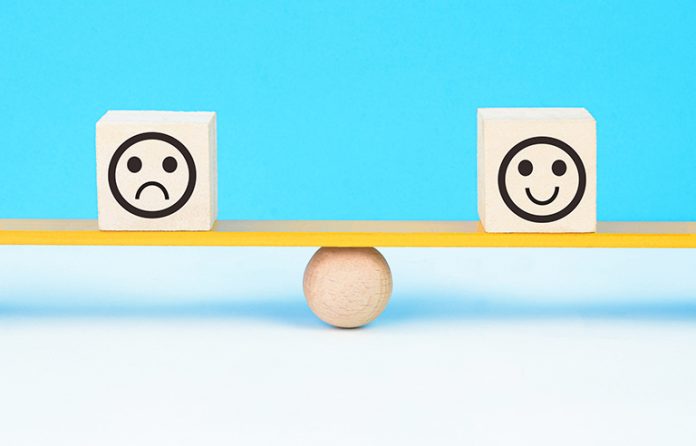 Happy face sad face balance concept
