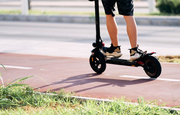 riding-a-scooter Teen boy legs on an electric scooter