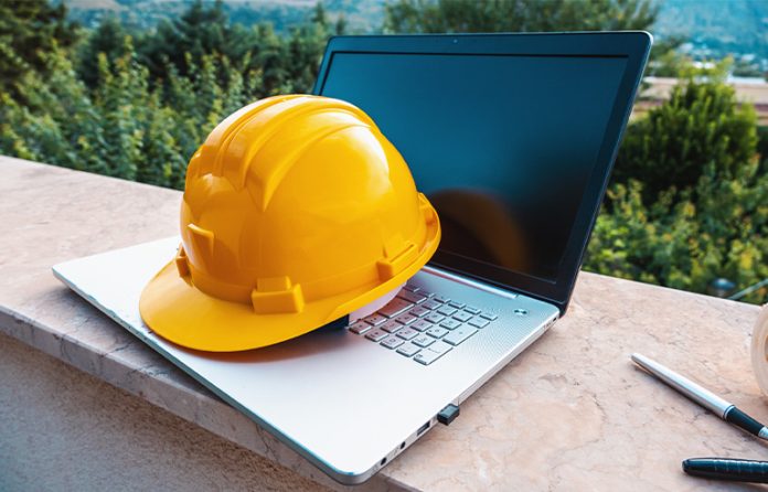 Hard hat on computer training concept