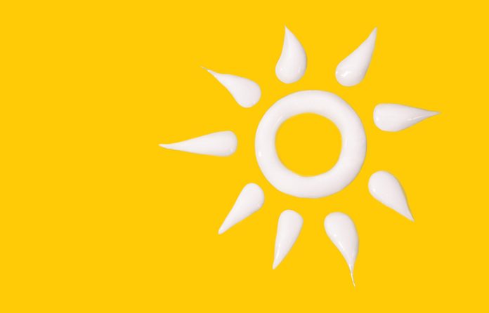 Sunscreen sun on yellow background